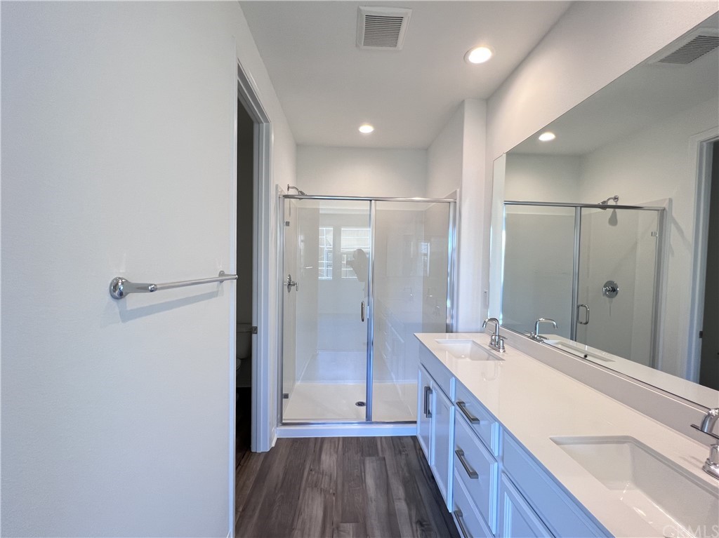 126 Sawbuck Irvine, CA 92618 - Photo 6 of 10 a bathroom with a double vanity sink a toilet and shower