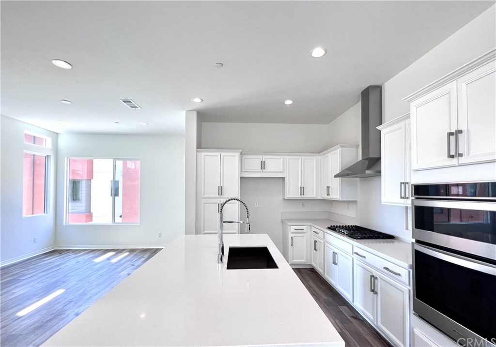 126 Sawbuck Irvine, CA 92618 - Photo 8 of 10 a kitchen with a stove a sink and a refrigerator