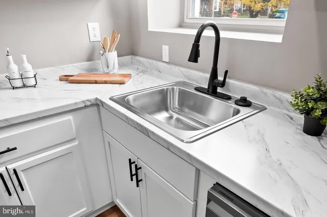 a dining room with furniture and a kitchen view
