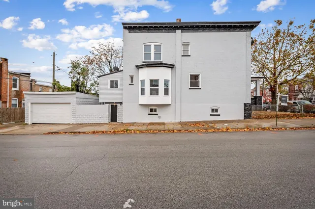 a front view of a house with a road