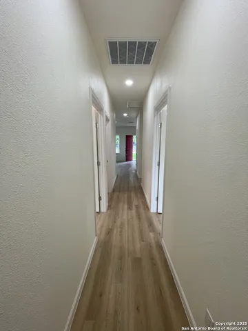 a view of hallway with wooden floor