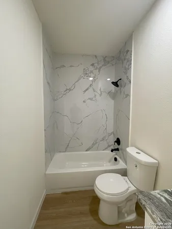 a bathroom with a toilet and a tub