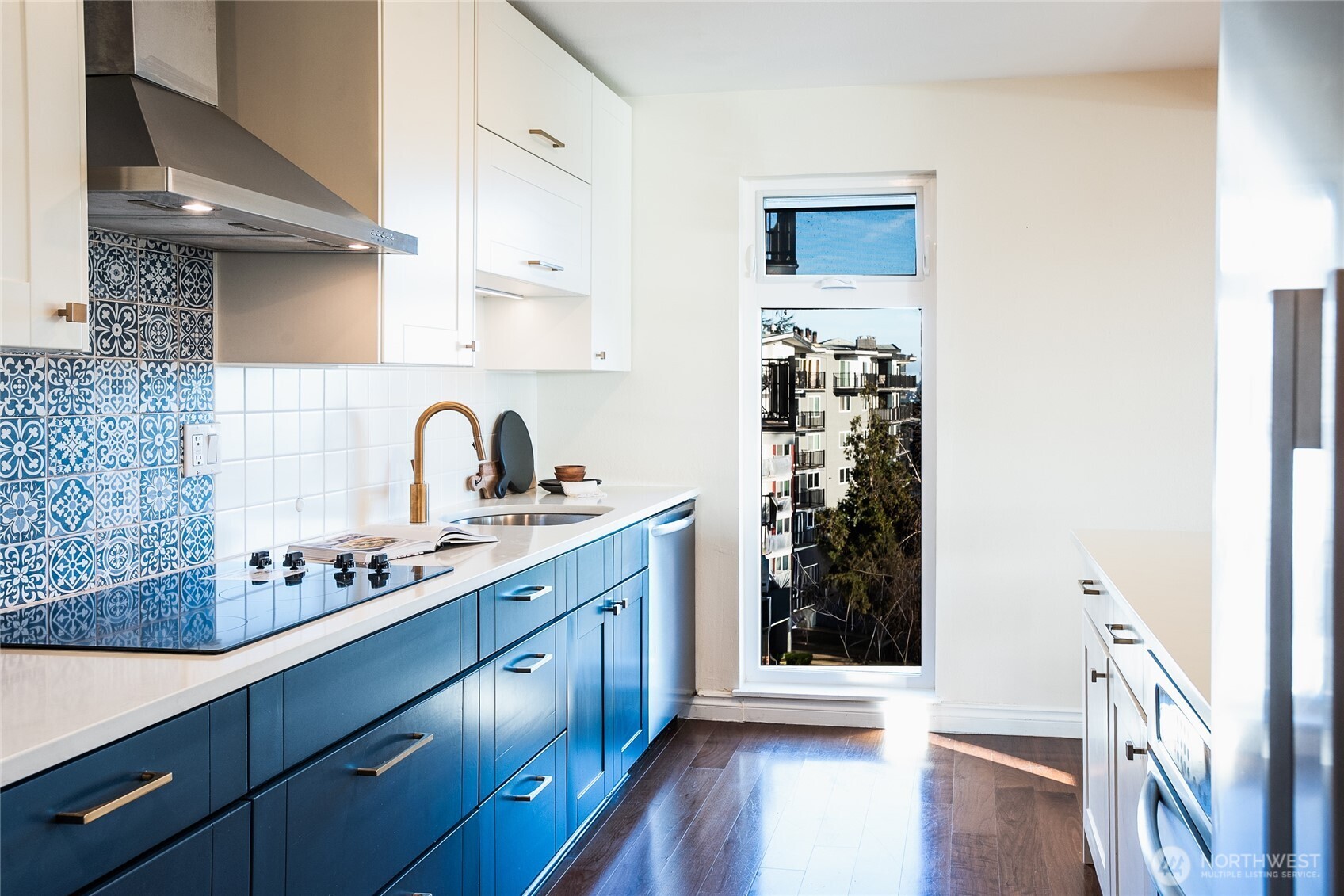 2510 West Bertona Street, Unit 428 Seattle, WA 98199 - Photo 6 of 35 a kitchen with wooden cabinets and a sink