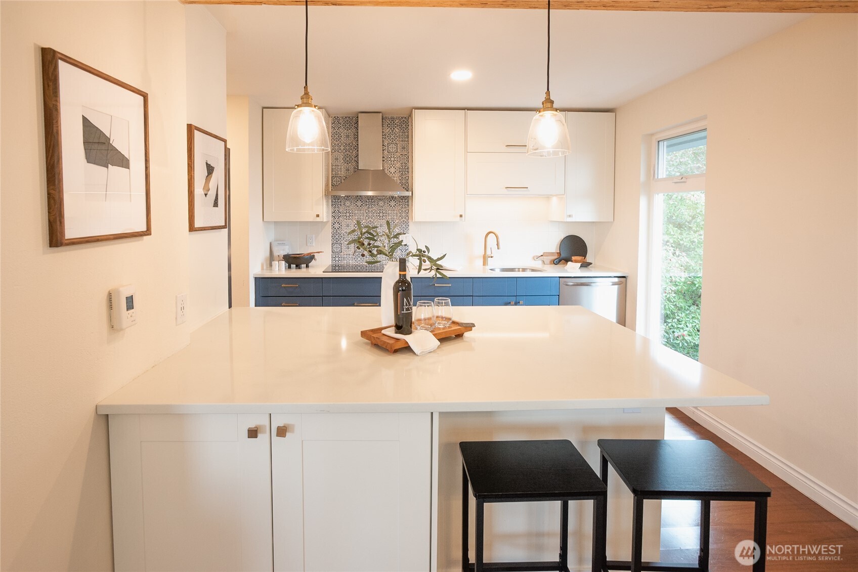 2510 West Bertona Street, Unit 428 Seattle, WA 98199 - Photo 10 of 35 a kitchen with stainless steel appliances a table and chairs in it