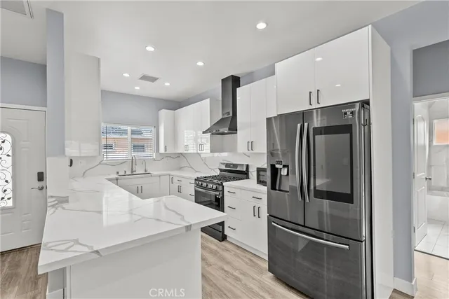 a kitchen with stainless steel appliances kitchen island granite countertop a refrigerator sink and stove
