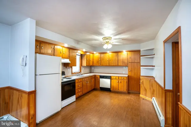 a kitchen with a refrigerator and a sink