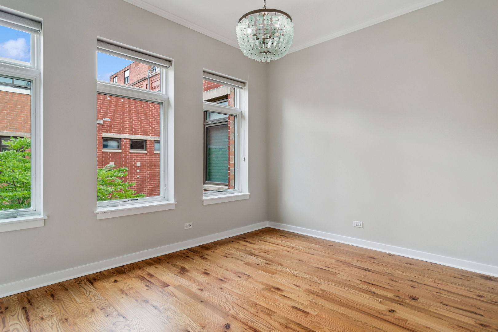 1648 South Prairie Avenue, Unit 4 Chicago, IL 60616 - Photo 18 of 30 an empty room with wooden floor and windows