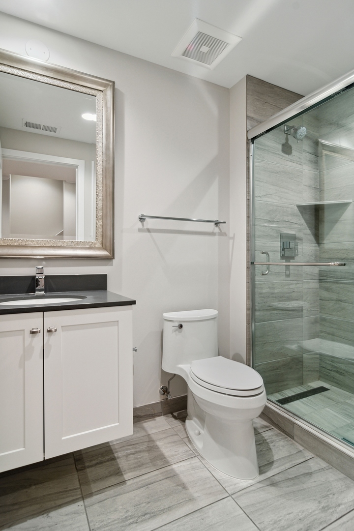 1648 South Prairie Avenue, Unit 4 Chicago, IL 60616 - Photo 29 of 30 a bathroom with a toilet a sink and shower
