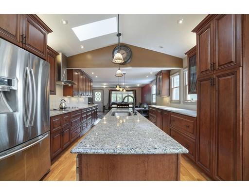18 Community Road Billerica, MA 01821 - Photo 3 of 22 a kitchen with stainless steel appliances granite countertop a refrigerator a sink and wooden cabinets