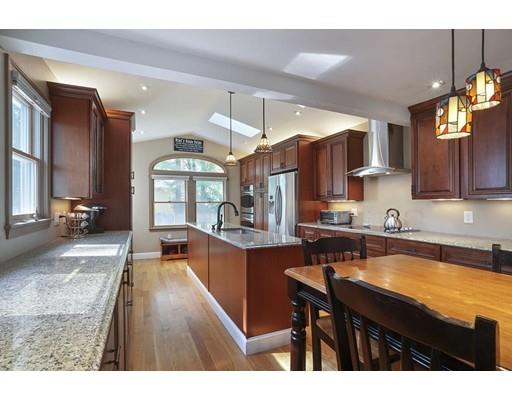 18 Community Road Billerica, MA 01821 - Photo 4 of 22 a kitchen with wooden floors and wooden cabinets