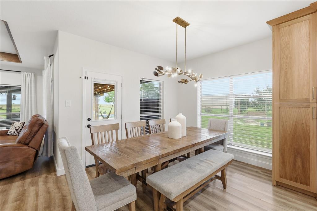 430 Ridgecrest Place Sanger, TX 76266 - Photo 11 of 40 Dining area featuring wood-finish flooring and a contemporary chandelier