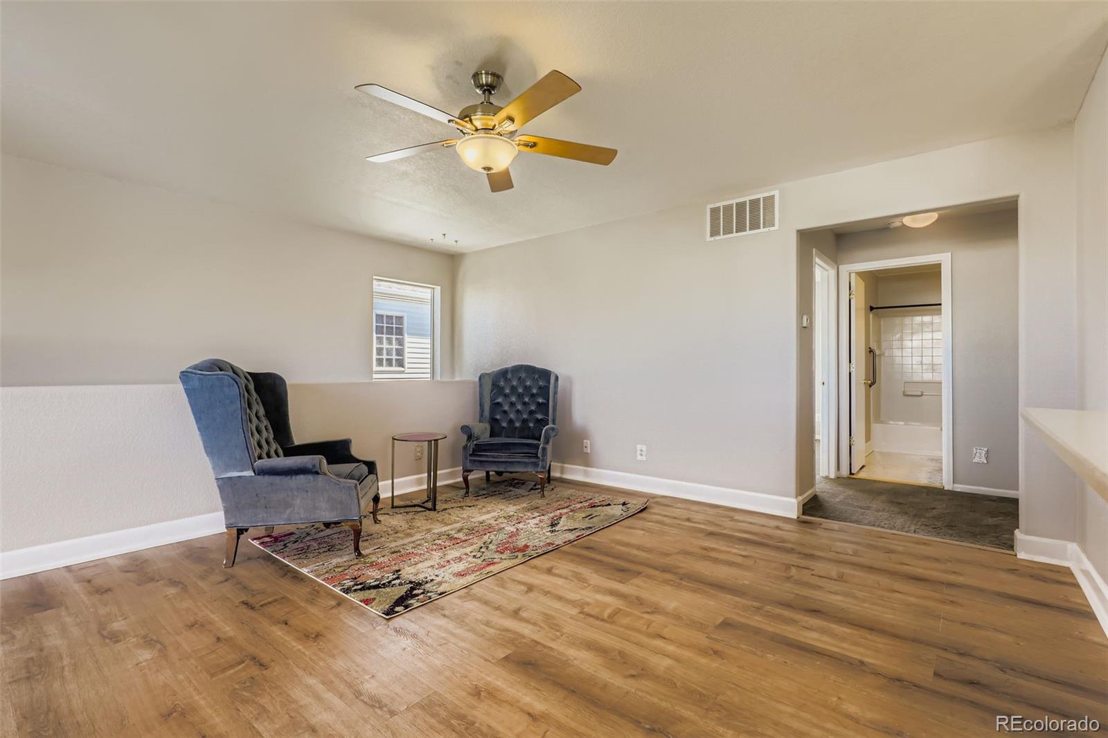 4716 Andes Street Denver, CO 80249 - Photo 13 of 27 a view of a workspace with furniture and a window