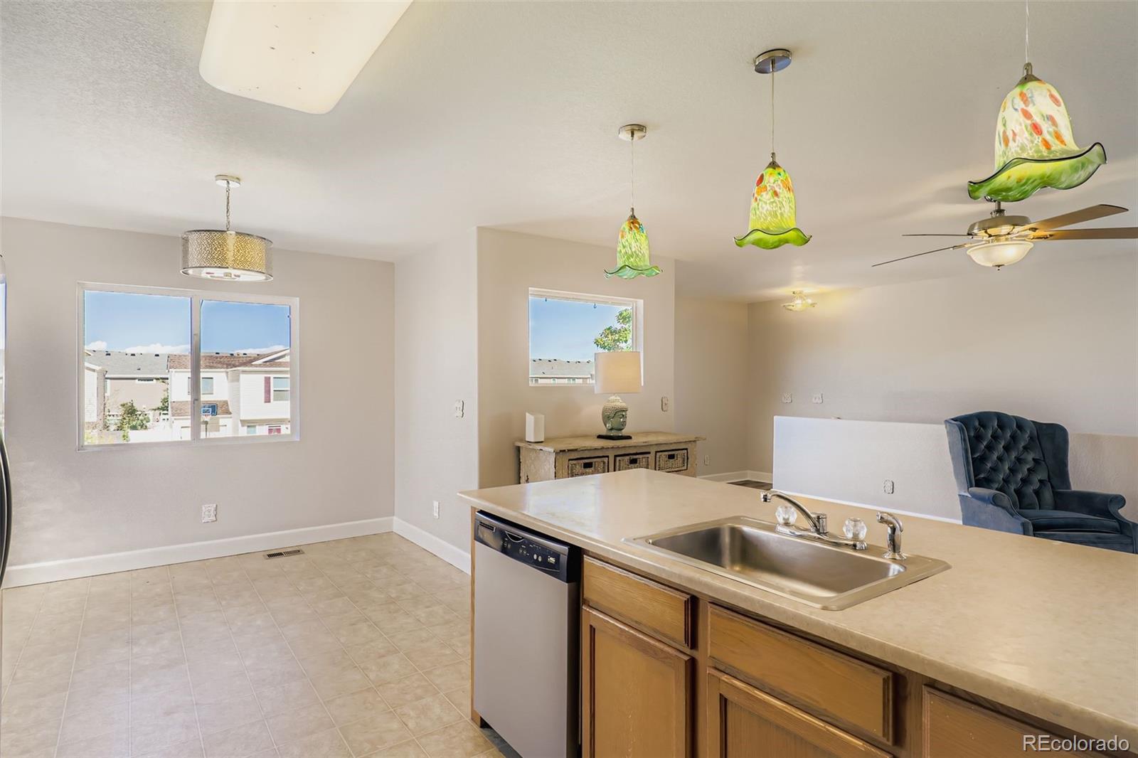 4716 Andes Street Denver, CO 80249 - Photo 16 of 27 a kitchen with a sink a counter space and window