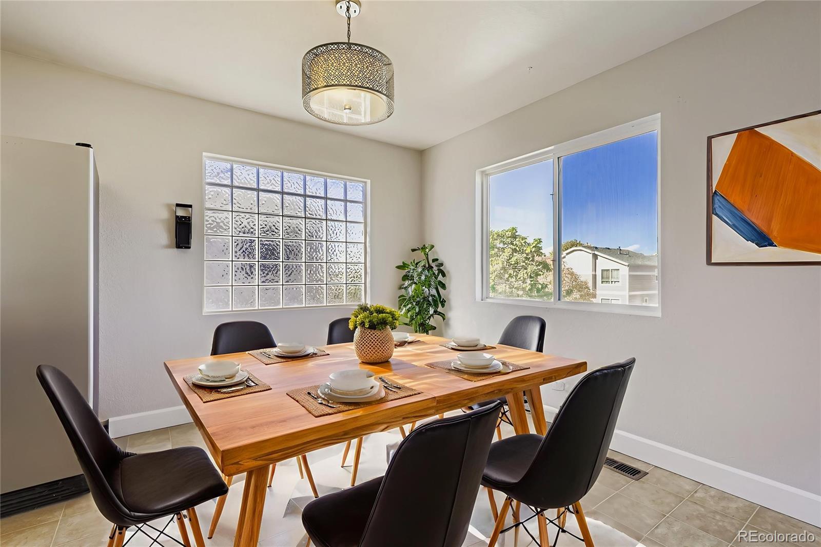 4716 Andes Street Denver, CO 80249 - Photo 17 of 27 a view of a dining room with furniture window and wooden floor