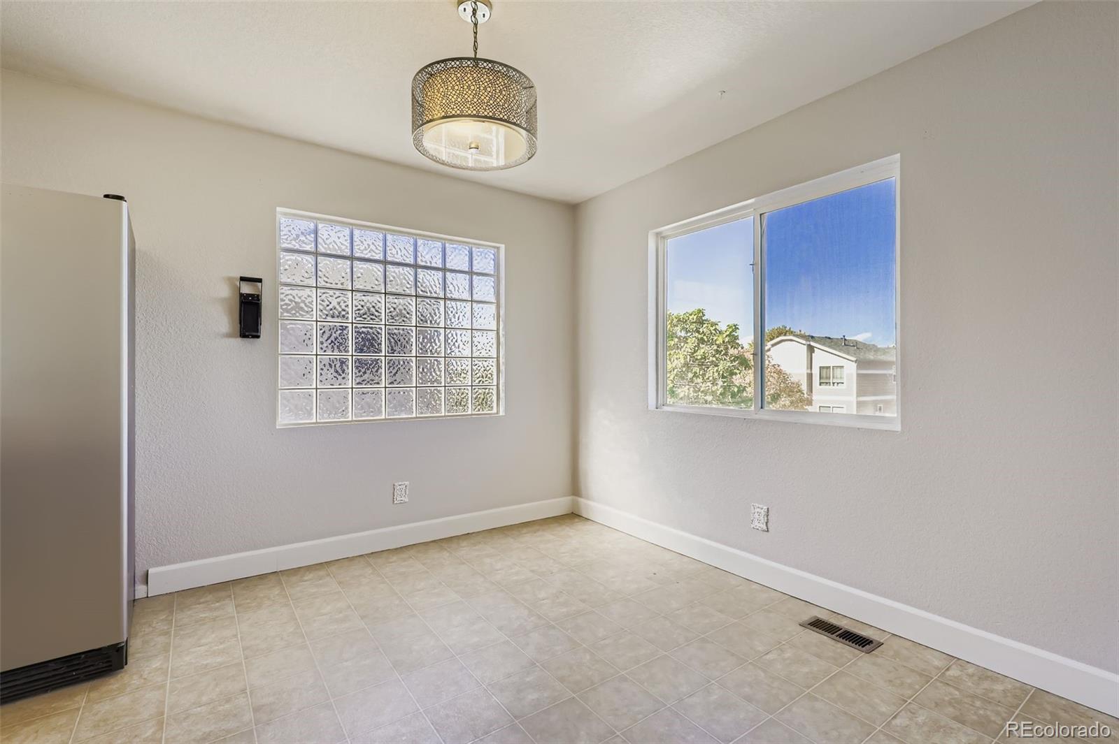 4716 Andes Street Denver, CO 80249 - Photo 18 of 27 a view of an empty room with a window