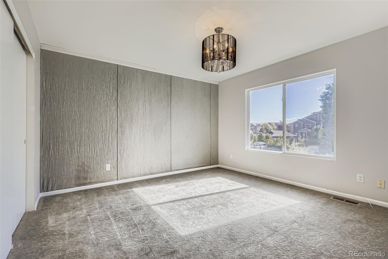 4716 Andes Street Denver, CO 80249 - Photo 20 of 27 a view of an empty room with a window