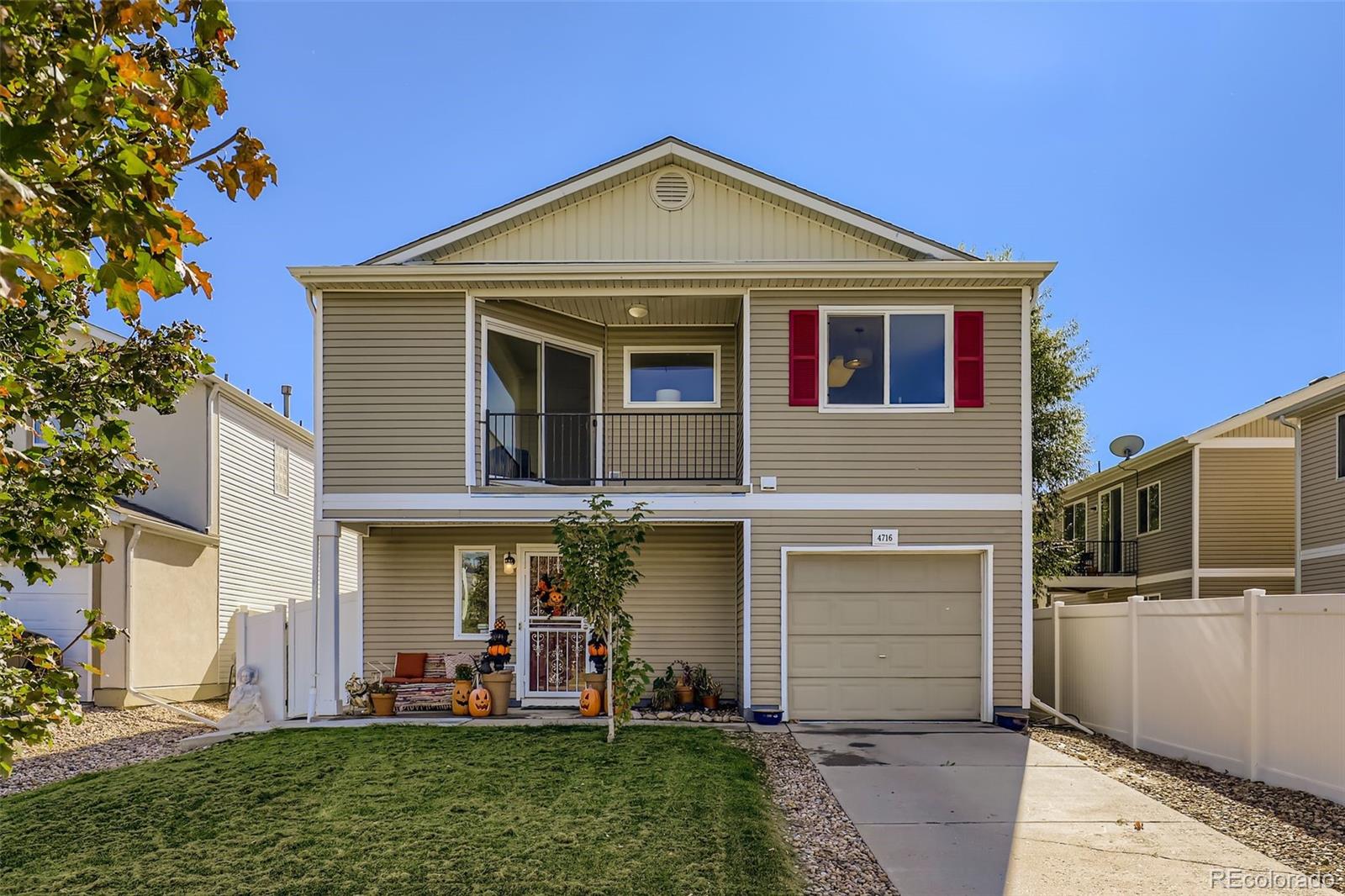 4716 Andes Street Denver, CO 80249 - Photo 2 of 27 a front view of a house with a yard