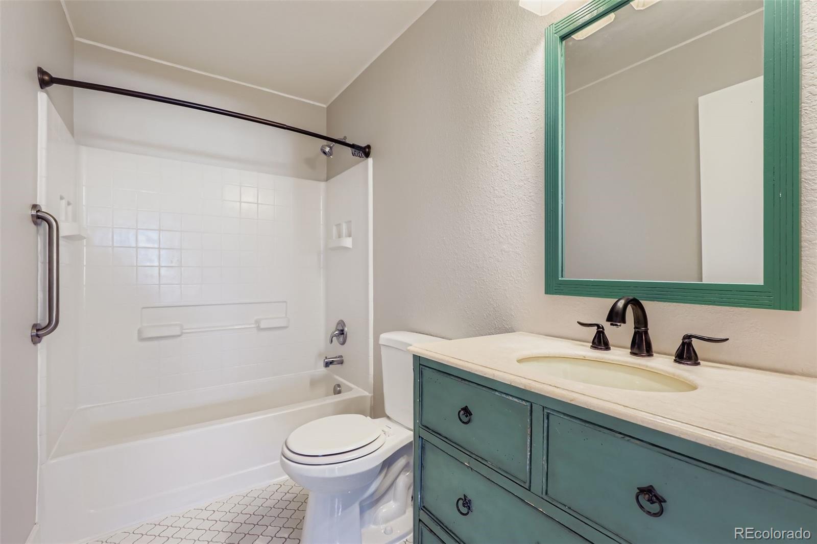 4716 Andes Street Denver, CO 80249 - Photo 21 of 27 a bathroom with a sink a toilet and shower