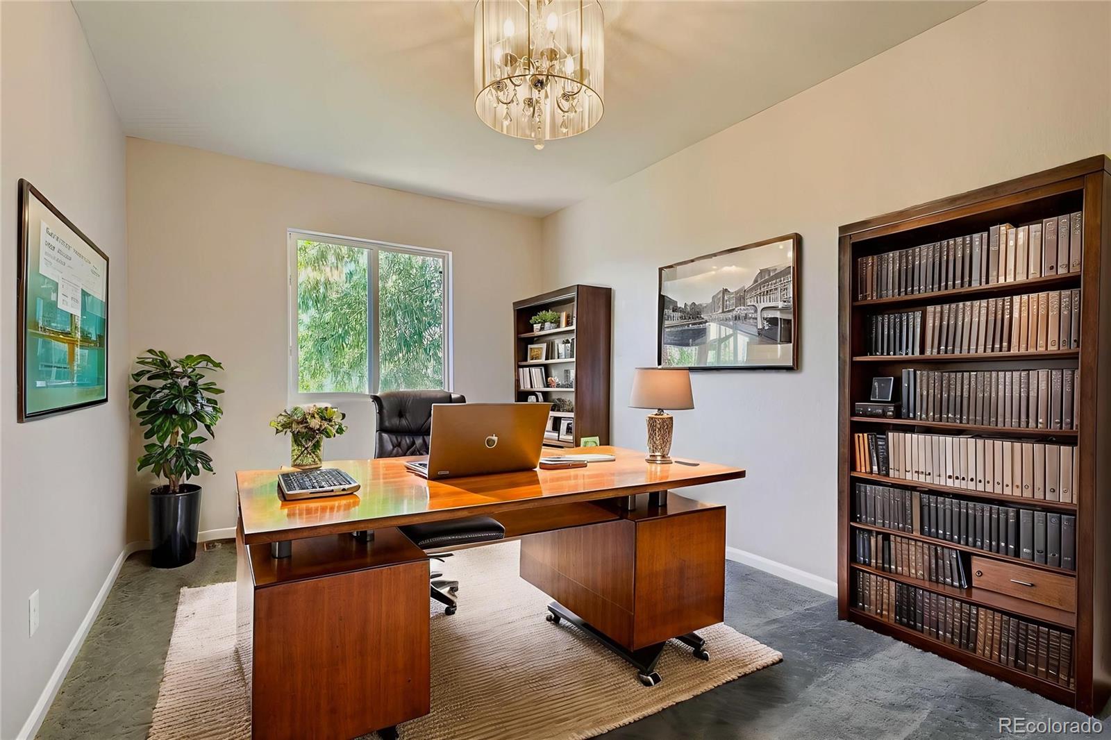 4716 Andes Street Denver, CO 80249 - Photo 22 of 27 a workspace with furniture and book shelf