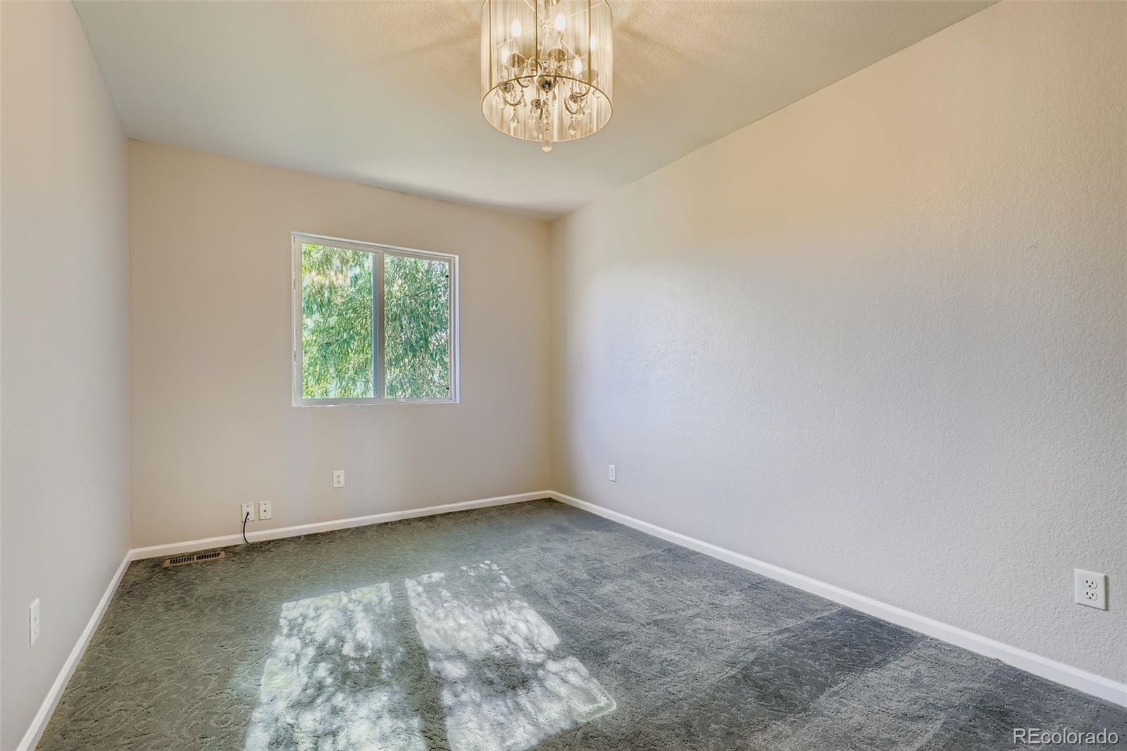 4716 Andes Street Denver, CO 80249 - Photo 23 of 27 an empty room with windows
