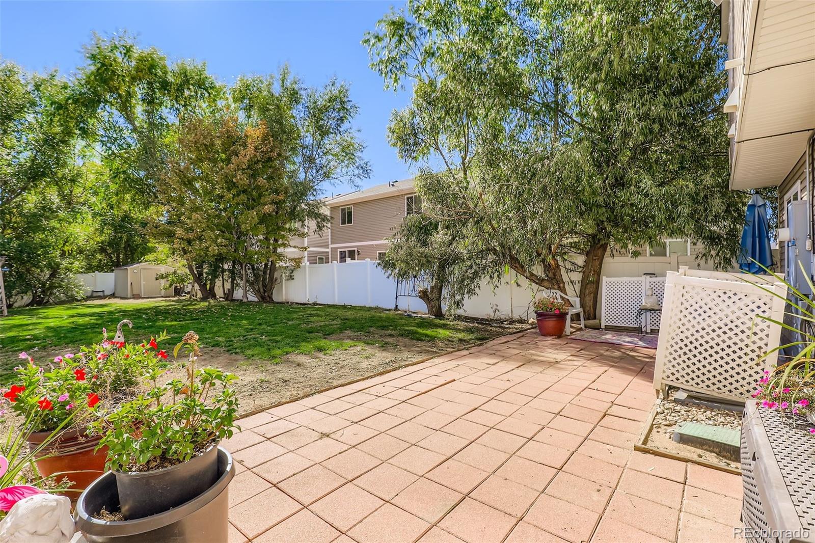 4716 Andes Street Denver, CO 80249 - Photo 24 of 27 a view of a backyard with chair and potted plants