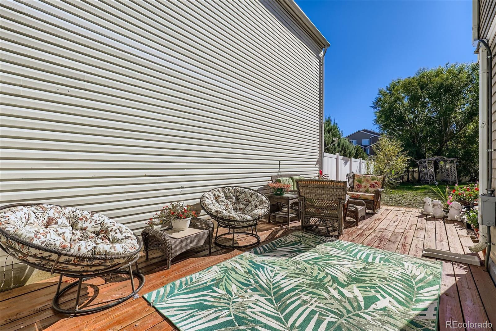 4716 Andes Street Denver, CO 80249 - Photo 25 of 27 a view of a patio with couple of chairs and a fire pit
