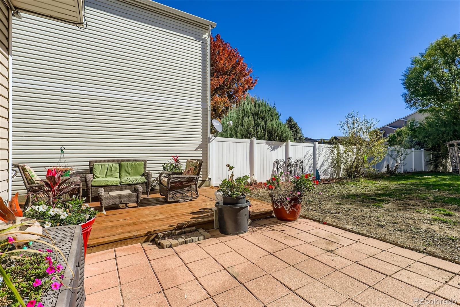 4716 Andes Street Denver, CO 80249 - Photo 26 of 27 a view of a chairs and tables in the backyard