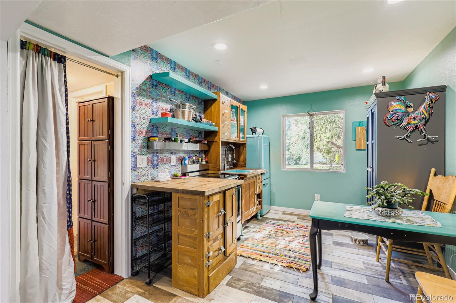 4716 Andes Street Denver, CO 80249 - Photo 3 of 5 a kitchen with stainless steel appliances granite countertop a stove and a refrigerator
