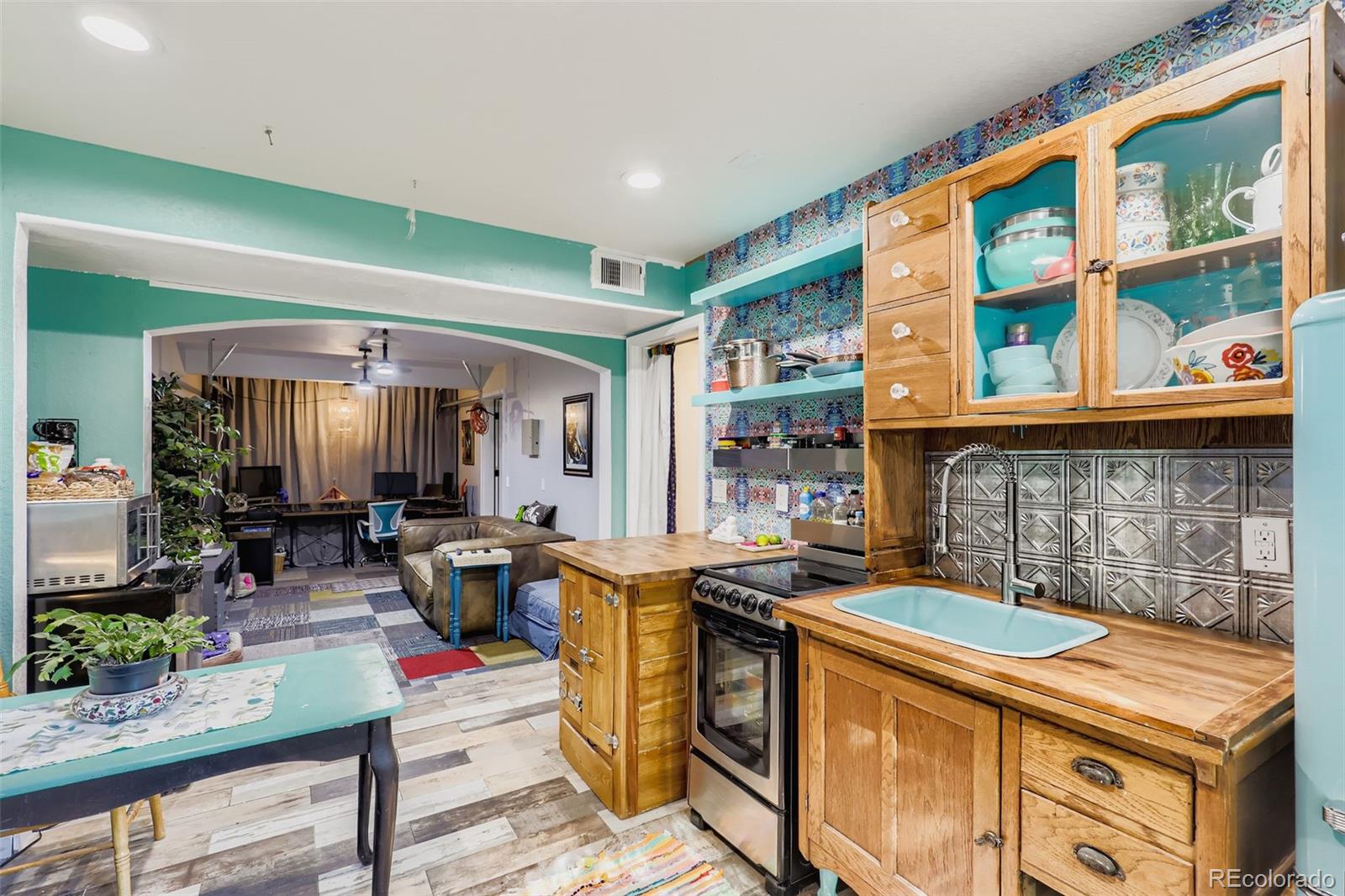 4716 Andes Street Denver, CO 80249 - Photo 7 of 27 a open kitchen with stainless steel appliances granite countertop a stove and a dining table