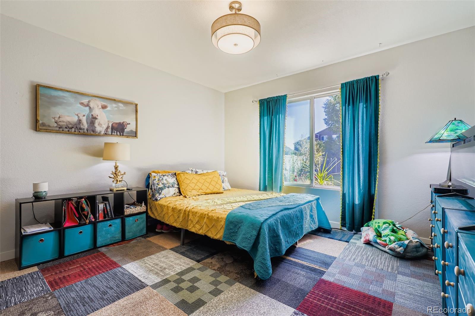 4716 Andes Street Denver, CO 80249 - Photo 9 of 27 a bedroom with a bed table and a window