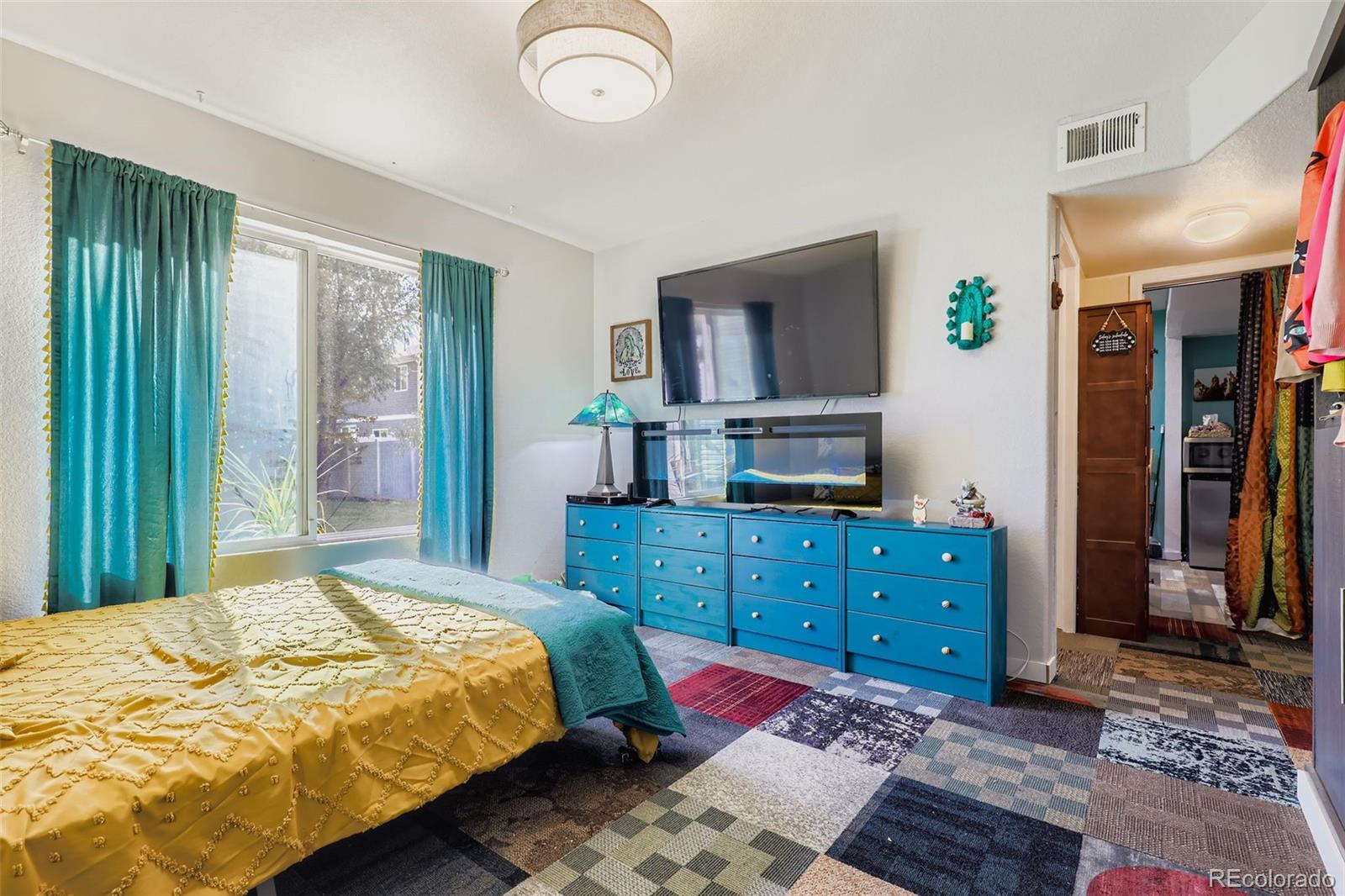 4716 Andes Street Denver, CO 80249 - Photo 10 of 27 a bedroom with a bed and a dresser in it