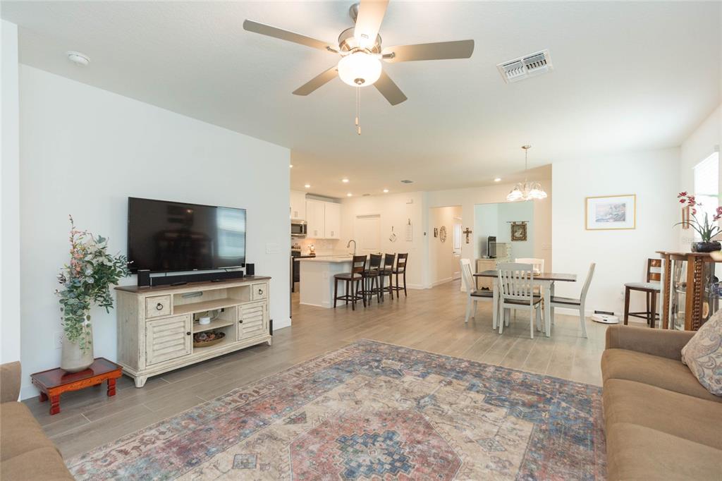 10806 Gable Dig Loop San Antonio, FL 33576 - Photo 12 of 73 a living room with furniture and a flat screen tv