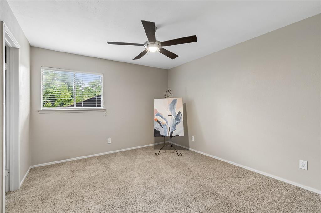 4962 Thunder Road Dallas, TX 75244 - Photo 23 of 26 The secondary bedroom has a walk-in closet and access to the adjoining bathroom.