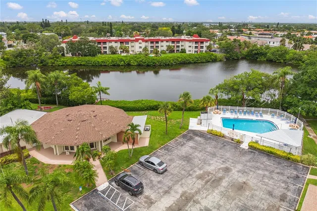 an aerial view of a house with a garden and lake view