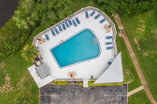an aerial view of a house with a garden and swimming pool