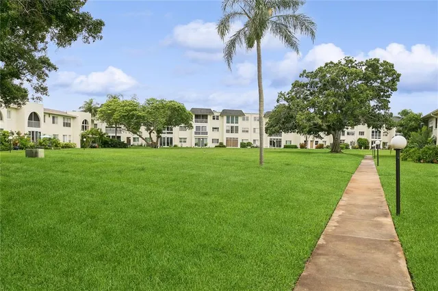 a front view of a house with yard and green space
