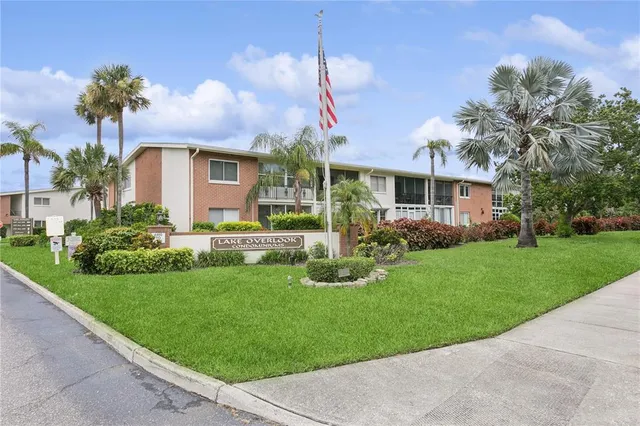 a front view of a house with a yard and potted plants