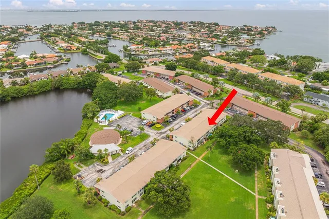 an aerial view of residential houses with outdoor space and river