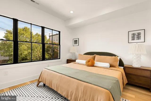 a bedroom with a large bed and a large window