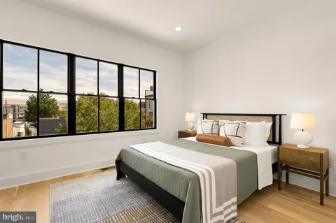 a bedroom with a large bed and a large window