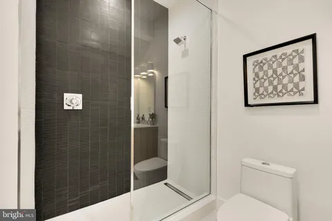 a bathroom with a toilet and a shower