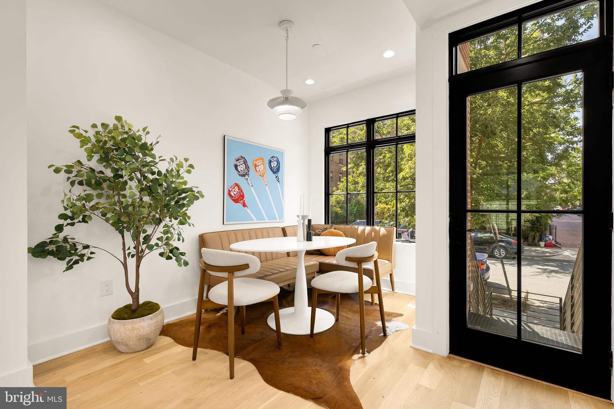 1205 10th Street Northwest, Unit 1 Washington, DC 20001 - Photo 2 of 33 a view of a dining room with furniture large windows and wooden floor