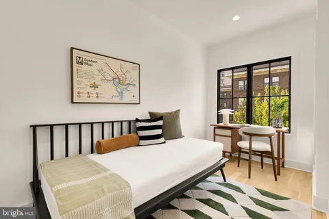 a bedroom with a bed and a table in it