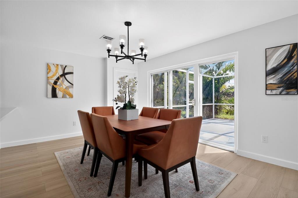 4210 Palm Drive Punta Gorda, FL 33950 - Photo 11 of 30 a view of a dining room with furniture window and wooden floor