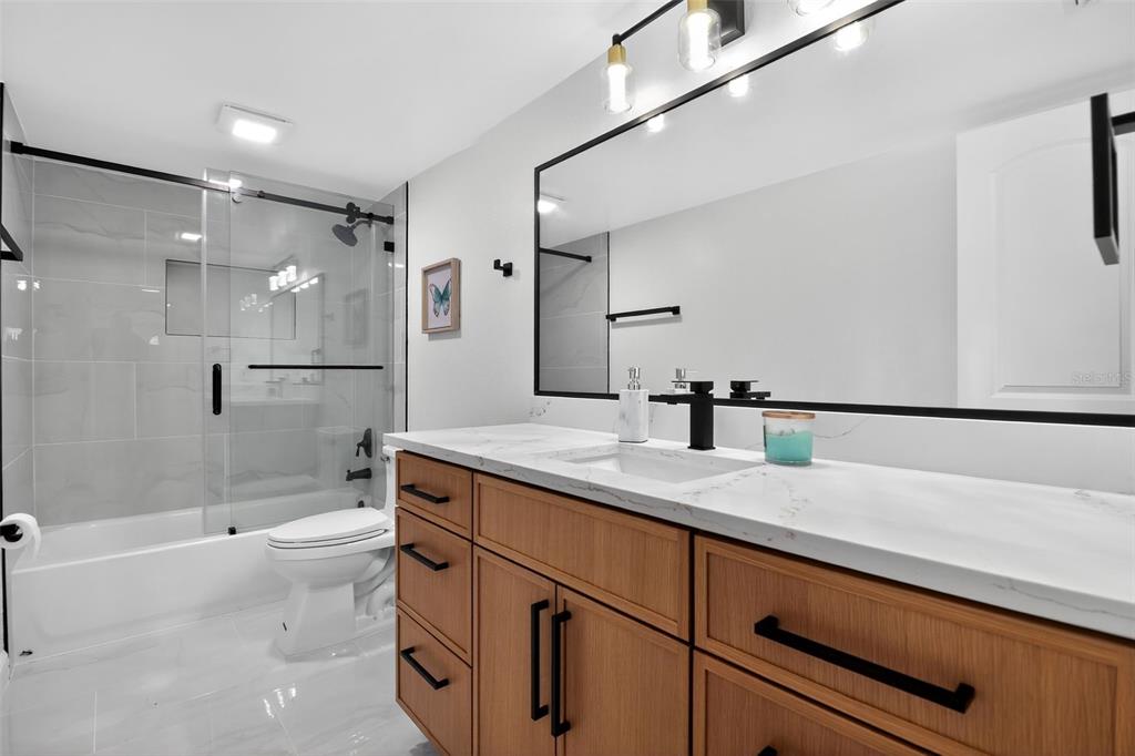 4210 Palm Drive Punta Gorda, FL 33950 - Photo 12 of 30 a bathroom with a granite countertop sink mirror and shower