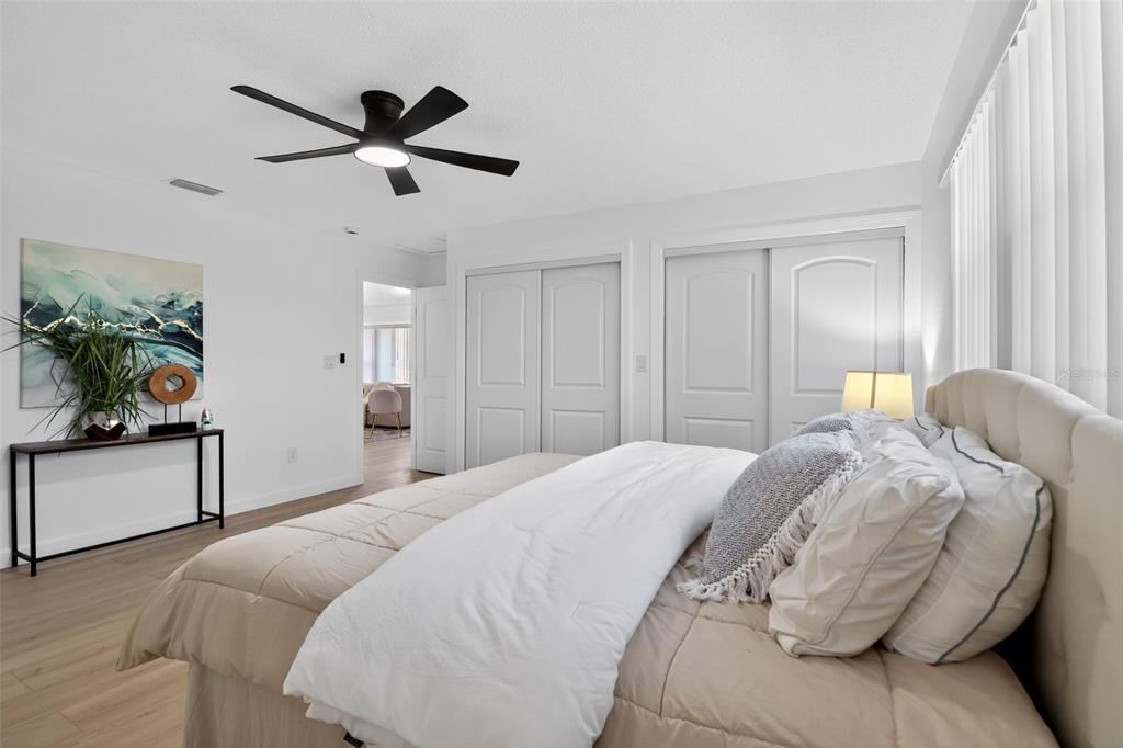 4210 Palm Drive Punta Gorda, FL 33950 - Photo 16 of 30 a spacious bedroom with a bed and a chandelier