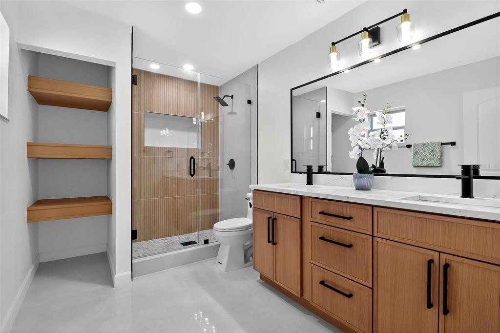 4210 Palm Drive Punta Gorda, FL 33950 - Photo 17 of 30 a spacious bathroom with a shower sink and mirror