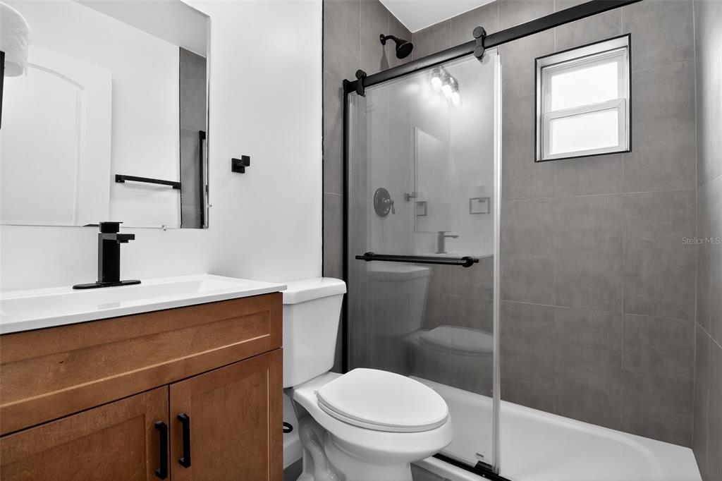 4210 Palm Drive Punta Gorda, FL 33950 - Photo 23 of 30 a bathroom with a toilet a sink and shower