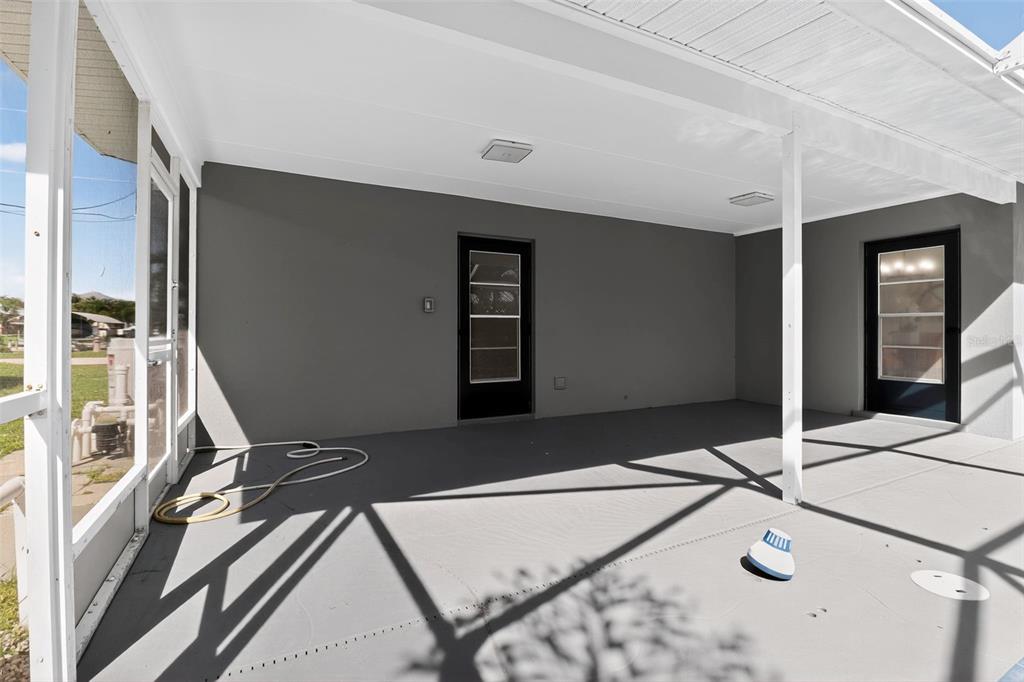 4210 Palm Drive Punta Gorda, FL 33950 - Photo 25 of 30 a balcony view with two chairs and a projector screen