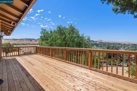 a view of balcony with wooden floor and fence